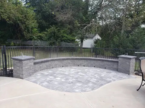 Paver patio with a seat wall and pillars